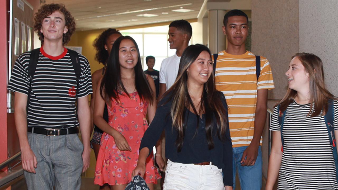 teenagers walking in a school corridor