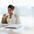woman sitting at desk looking at computer