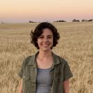 Emma Mechelke, winner of the Michael and Sheila Lewis Scholarship in brewing, poses in front of a field of wheat